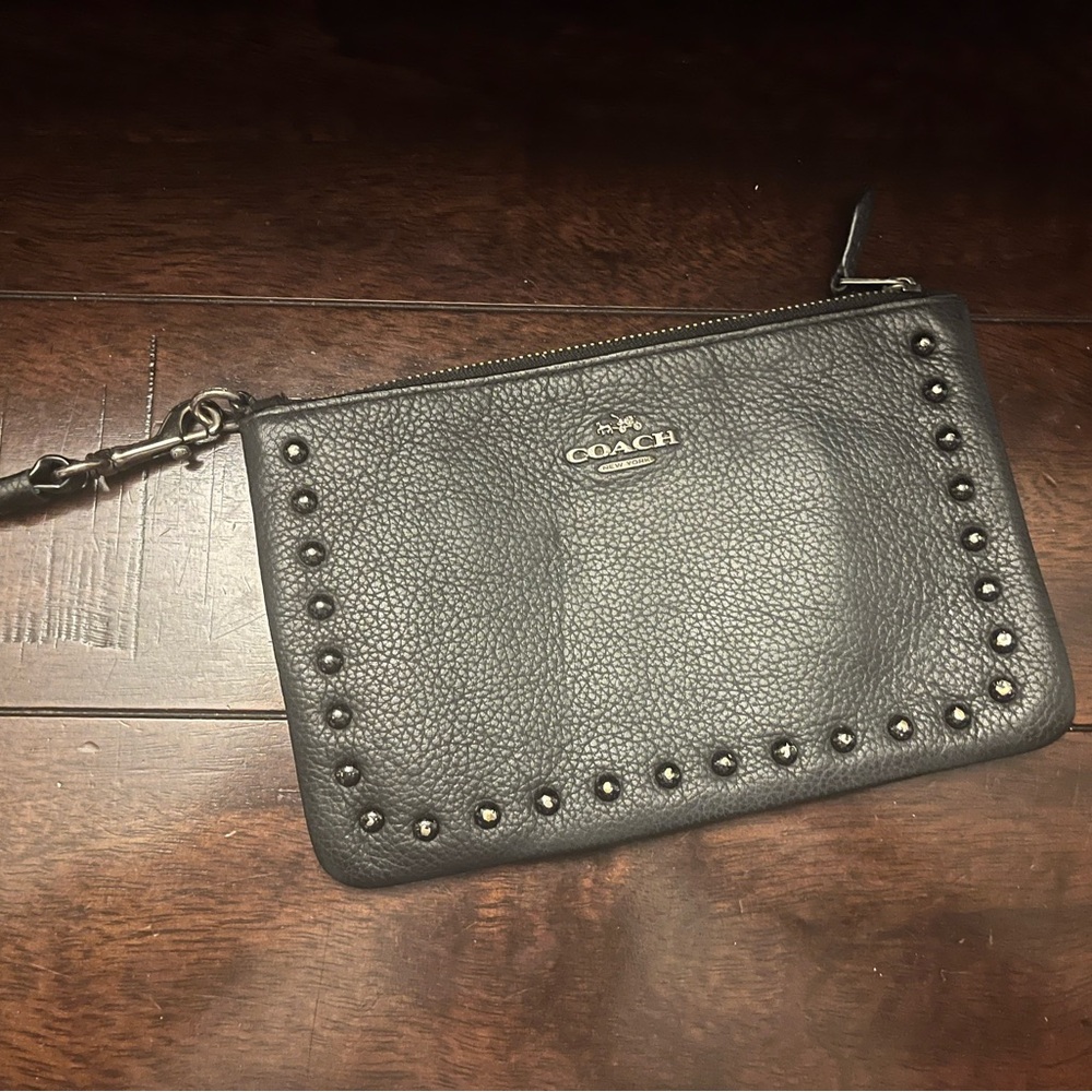 Black leather Coach wristlet with gunmetal hardware